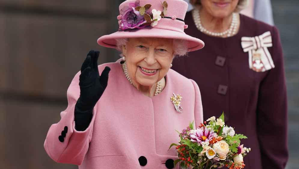 Queen Elizabeth II smiling and waving.